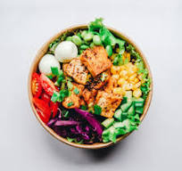 High protein salmon bowl with greens and corn